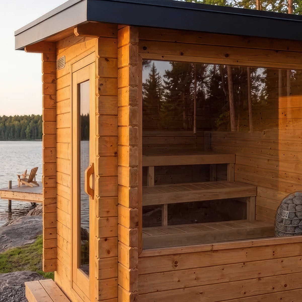 Canadian Timber Avalon sauna at sunset with the three-tier bench system visible through the tempered glass front window
