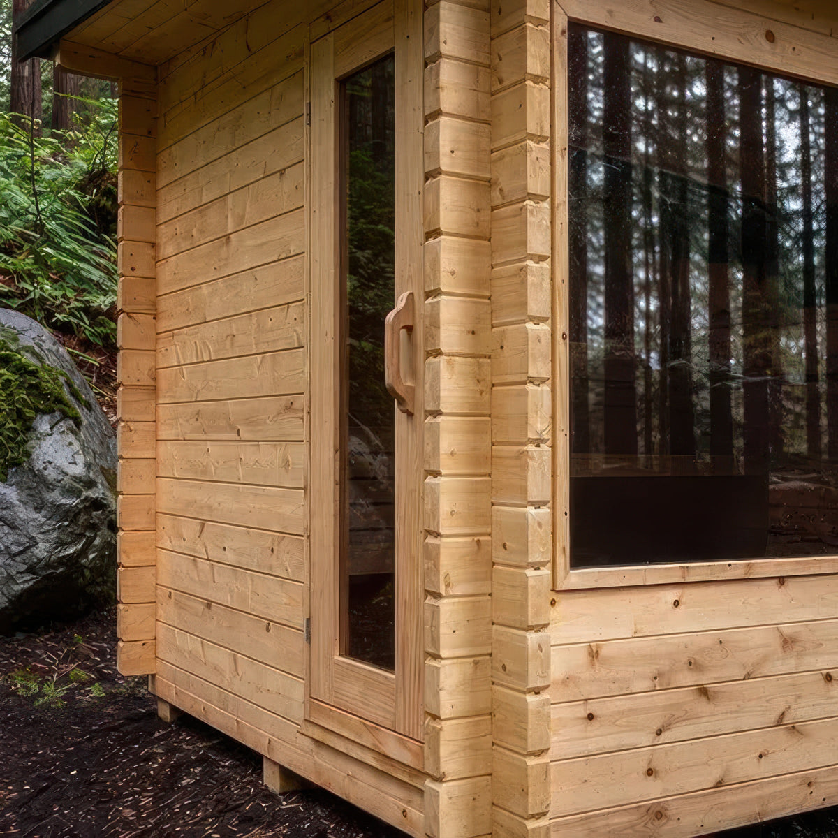 Corner detail of the Canadian Timber Avalon sauna showing the 2-3/4 inch double-groove Eastern White Cedar log wall and door