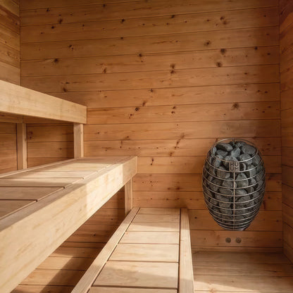 Canadian Timber Avalon sauna interior detail of the cedar bench edge and the stone-filled sauna heater